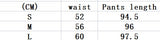 Size chart for chessboard plaid yoga bell-bottoms, displaying waist and pants length measurements for sizes S, M, and L in centimeters.