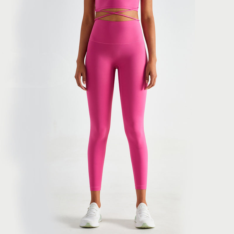 Bright pink high-waisted yoga pants with a slim fit and moisture-wicking fabric. Perfect for workouts and casual wear. Available in various sizes.