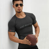 Dark gray athletic compression shirt with 'PRO-SMITH' branding. Ideal for running, gym workouts, and sports activities.