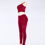 Side view of red women’s yoga set displayed on a mannequin. Quick-dry fabric with a snug, flexible fit for workouts.