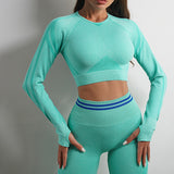 Mint green seamless yoga pants and long sleeve top. Slim-fit, stretchy sportswear for gym and fitness activities.