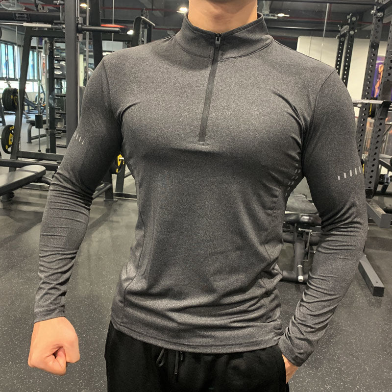 Grey half-zipper fitness sweatshirt with breathable fabric, ensuring sweat absorption and a snug fit for intense training sessions.