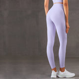 Light purple moisture-wicking yoga pants with a high waist and slim fit. Great for running, yoga, and gym sessions. Available in various sizes.