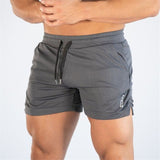 Men's fitness quick-dry shorts in dark gray, designed for gym and outdoor use. Made from breathable polyester with an adjustable drawstring waist.