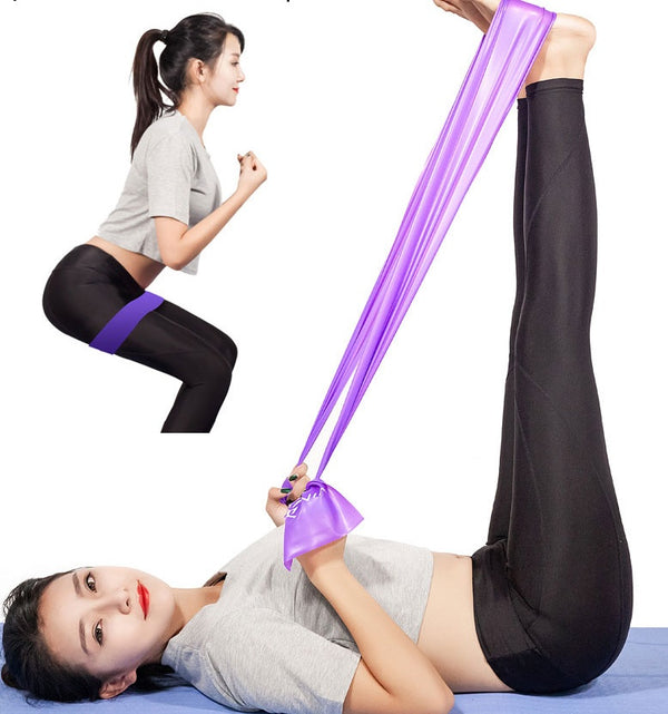 Woman using a purple yoga fitness resistance band for strength and flexibility exercises. Ideal for home workouts and improving muscle tone.