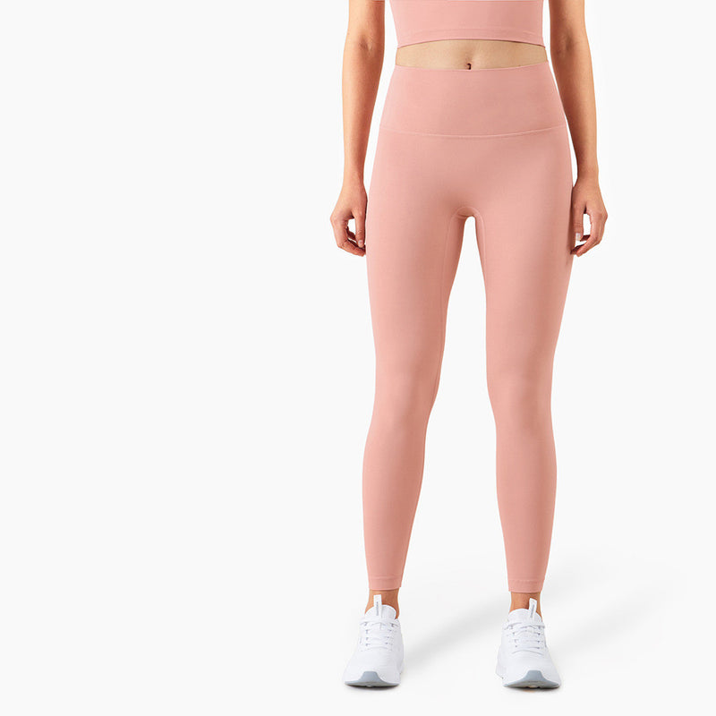 Soft pink yoga pants with a high waist and slim fit. Designed for comfort and flexibility during workouts. Available in multiple sizes.