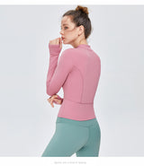 Back view of a pink women's yoga sports top with long sleeves and moisture-wicking fabric. Designed for fitness and yoga enthusiasts.