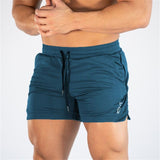 Men's fitness quick-dry shorts in teal, designed for gym and outdoor use. Made from breathable polyester with an adjustable drawstring waist.