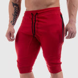 Red men's sports cotton shorts with black drawstrings and zippered pockets. Perfect for summer workouts, available in sizes M to XXL.