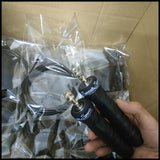 Hand holding black jump rope handles with metal connectors. Designed for high-speed skipping and endurance training.