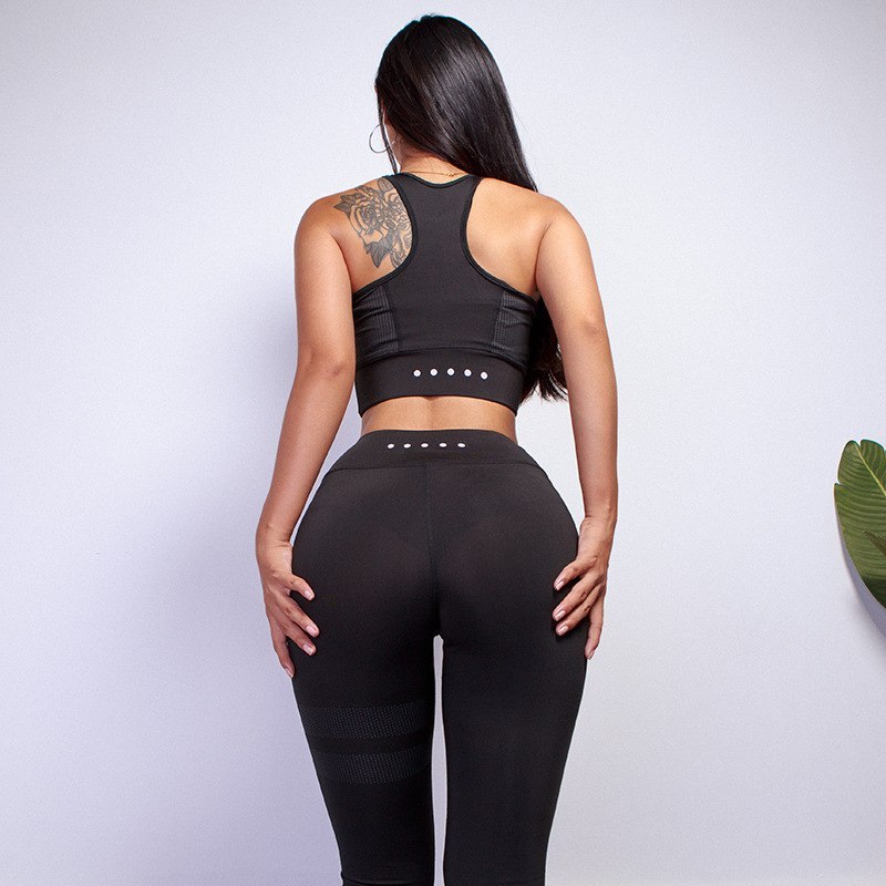 Black women’s sportswear yoga set with a racerback design and high-waisted leggings. Breathable and quick-drying for active wear.