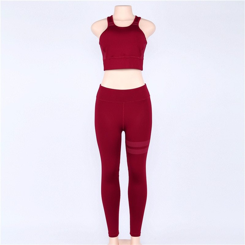 Front view of red women’s sportswear yoga set on a mannequin. Includes a racerback top and high-waisted leggings for comfort.