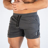 Men's fitness quick-dry shorts in dark gray, designed for gym and outdoor activities. Made from breathable polyester with an adjustable drawstring.