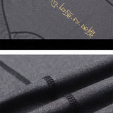 Close-up of black athletic shirt fabric with gold lettering. High-quality stitching and breathable material for comfort.