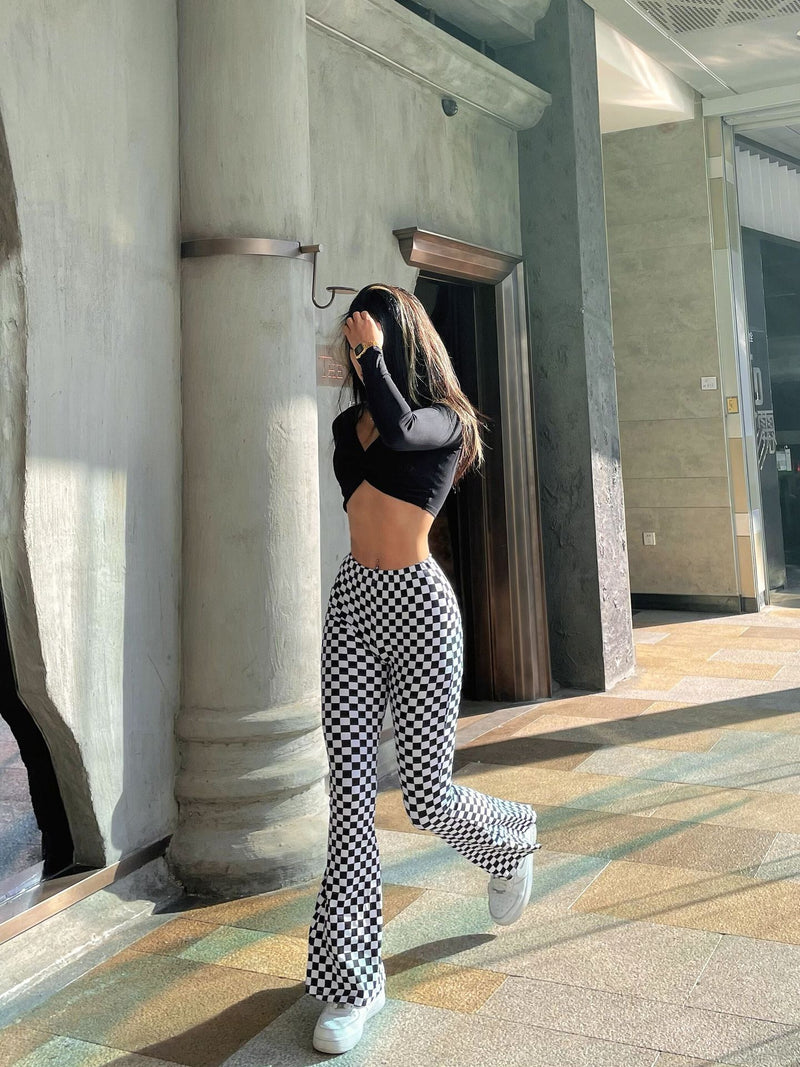 Side view of a model wearing chessboard plaid yoga bell-bottoms, showcasing the flared leg design. Comfortable and stylish for workouts or daily wear.