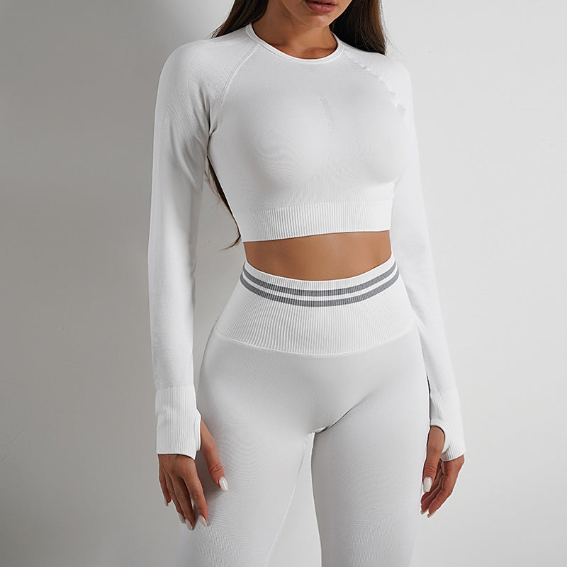 White seamless yoga pants and long sleeve top. Comfortable, high-waisted leggings for fitness and everyday wear.