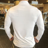 Back view of a white half-zipper fitness sweatshirt, showcasing a sleek design and stretchable fabric for unrestricted movement.