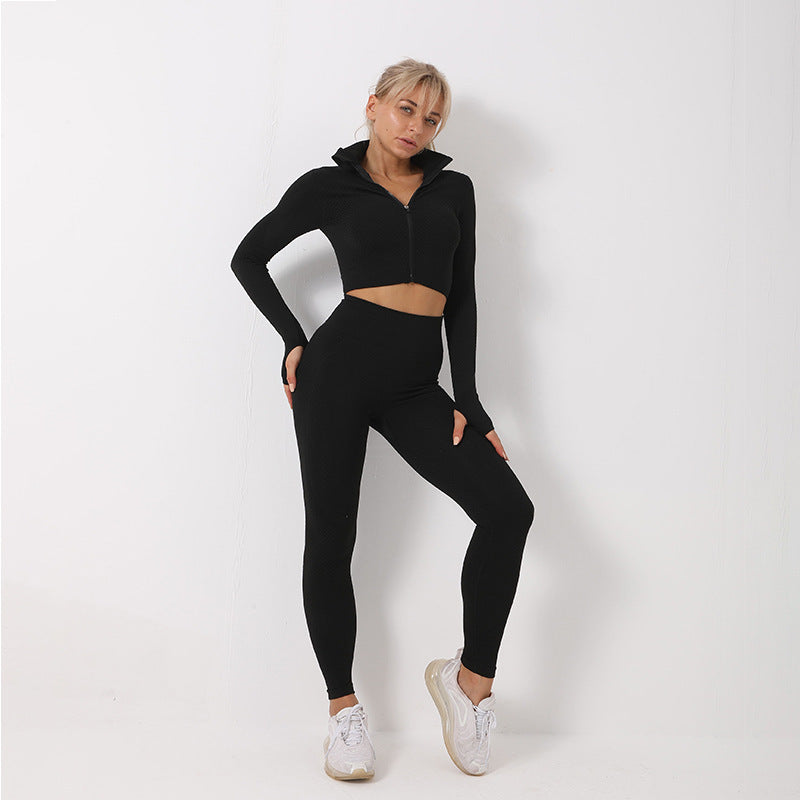 Black seamless yoga set for women. High-waisted leggings and zip-up jacket designed for comfort, flexibility, and quick-dry performance.