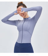 Women's moisture-wicking yoga sports top in light blue with long sleeves and zip-up front. Made from nylon and spandex for comfort and flexibility.