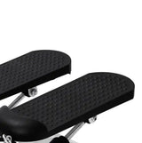 Close-up of the textured foot pedals on a mini stepper, designed for stability and comfort during cardio and strength training exercises.