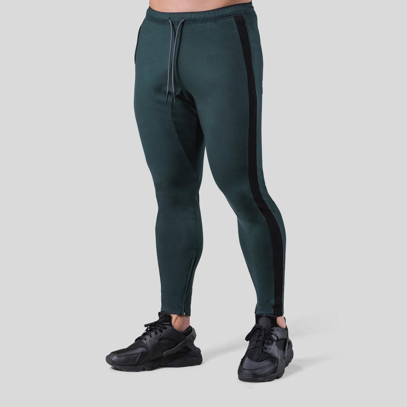 Fitness pants for men made of polyester, designed for workouts and fitness exercises. Available in green with black side stripes, sizes M-XXXL.