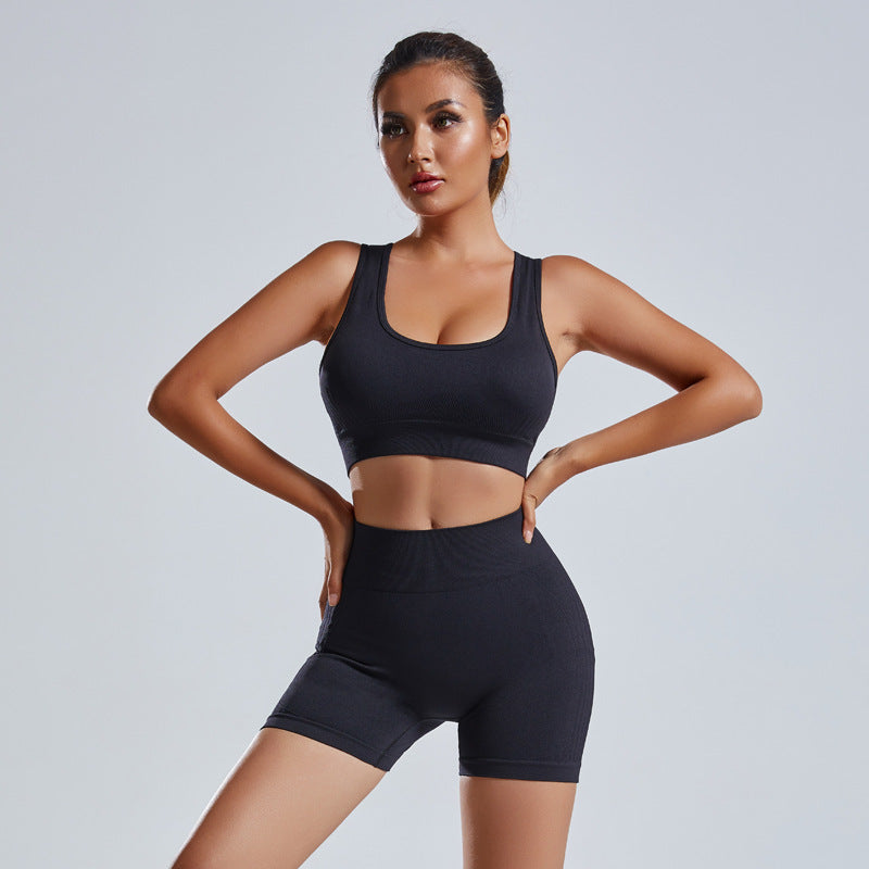 Women's vest and shorts workout tracksuit in black, featuring a sleeveless crop top and high-waisted shorts. Designed for comfort and flexibility.