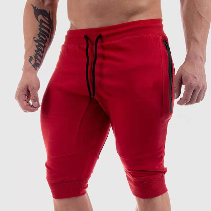 Men's red summer fitness shorts with black drawstrings and zippered pockets. Comfortable cotton fabric, available in sizes M to XXL.