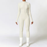 Cream-colored yoga jumpsuit with long sleeves and a front zipper. Made from moisture-wicking polyester, perfect for fitness and running.