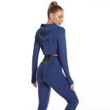 Back view of a seamless blue workout outfit with a hooded crop top and scrunch leggings. Designed for flexibility, support, and a flattering fit.