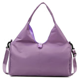 Purple women's large yoga bag featuring a sleek design, sturdy handles, and a detachable shoulder strap for versatile carrying options.