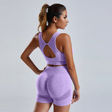 Purple women's workout tracksuit set with a racerback vest and high-waisted shorts. Designed for comfort and style during workouts.