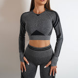 Seamless yoga pants and long sleeve top set in dark gray with black accents. Butt-lifting, slim-fit workout sportswear for gym and fitness activities.