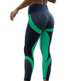 Black and green seamless leggings with a honeycomb pattern, designed for comfort and flexibility during workouts.