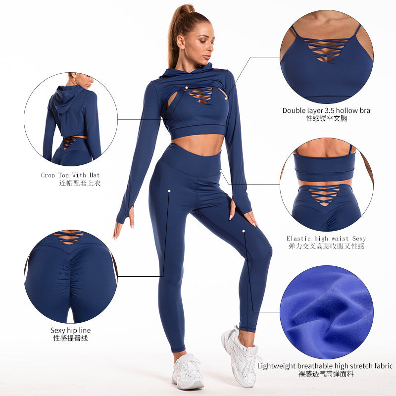 Detailed view of a seamless workout outfit in blue nylon. Features a cutout sports bra, high-waisted leggings, and a hooded crop top for activewear style.