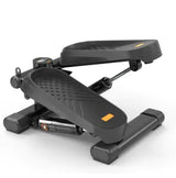 Black mini stepper with hydraulic resistance and textured foot pedals, designed for effective home workouts and muscle toning.